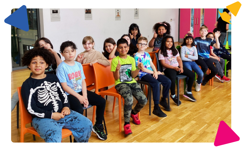 A group of young people aged 8 to 12 years old, sitting in our dance studio, waiting to play musical chairs
