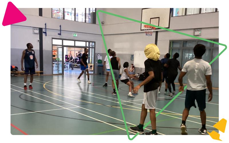 A group of young men playing basketball in the sports hall